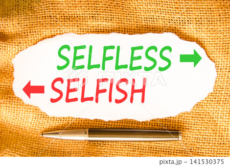 Selfless instead selfish words symbol. Concept words Selfless Selfish on beautiful white paper. Beautiful canvas background. Business medical psychology selfless selfish concept. Copy space. Selfless instead selfish words symbol. Concept words Selfless Selfish on beautiful white paper. Beautiful canvas background. Business medical psychology selfless selfish concept. Copy space. 141530375