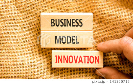 Business model innovation words symbol. Concept words Business model innovation on beautiful wooden blocks. Beautiful canvas background. Businessman hand. Business model innovation concept Copy space 141530715