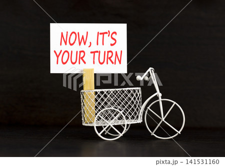 Now it's your turn words symbol. Concept words Now it's your turn on beautiful white paper. Beautiful black background. Business Now it's your turn motivational support concept. Copy space. Now it's your turn words symbol. Concept words Now it's your turn on beautiful white paper. Beautiful black background. Business Now it's your turn motivational support concept. Copy space. 141531160