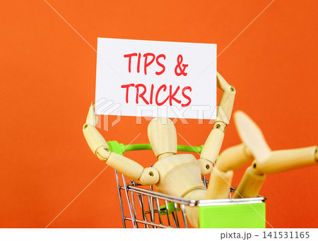 Tips and tricks words symbol. Concept words Tips and tricks on beautiful white paper. Beautiful orange background. Businessman model. Business tips and tricks motivational support concept Copy space Tips and tricks words symbol. Concept words Tips and tricks on beautiful white paper. Beautiful orange background. Businessman model. Business tips and tricks motivational support concept Copy space 141531165