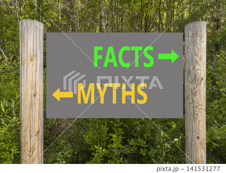 Facts or myths words symbol. Concept words Myths and Facts on beautiful road sign. Beautiful green forest background. Business and facts or myths concept. Copy space. 141531277