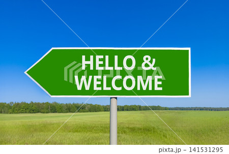 Hello and welcome symbol. Concept words Hello and welcome on beautiful green road sign. Beautiful blue sky green grass field background. Business hello and welcome concept. Copy space. Hello and welcome symbol. Concept words Hello and welcome on beautiful green road sign. Beautiful blue sky green grass field background. Business hello and welcome concept. Copy space. 141531295