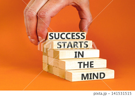 Success starts in the mind symbol. Concept words Success starts in the mind on beautiful wooden blocks. Beautiful orange background. Business and success starts in the mind concept. Copy space. Success starts in the mind symbol. Concept words Success starts in the mind on beautiful wooden blocks. Beautiful orange background. Business and success starts in the mind concept. Copy space. 141531515