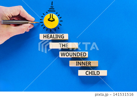 Healing the wounded inner child symbol. Concept words Healing the wounded inner child on beautiful wooden blocks. Beautiful blue background. Psychological Healing inner child concept. Copy space. Healing the wounded inner child symbol. Concept words Healing the wounded inner child on beautiful wooden blocks. Beautiful blue background. Psychological Healing inner child concept. Copy space. 141531516