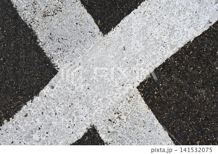 White Painted Cross Lines on Asphalt Texture Background White Painted Cross Lines on Asphalt Texture Background 141532075