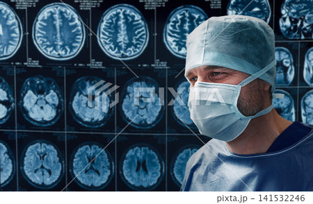Experienced neurosurgeon examining patient's head MRI scans before brain surgery. Neurology and cerebral diagnostics in clinic. Experienced neurosurgeon examining patient's head MRI scans before brain surgery. Neurology and cerebral diagnostics in clinic. 141532246