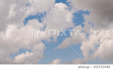 Soft white cumulus clouds spread across clear blue sky, creating airy open space, gentle daylight, calm weather mood, natural texture, and peaceful cloudscape with broad Soft white cumulus clouds spread across clear blue sky, creating airy open space, gentle daylight, calm weather mood, natural texture, and peaceful cloudscape with broad 141533440