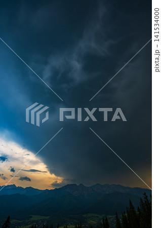 Dramatic Cumulonimbus Storm Clouds Above Mountain Forest Dramatic Cumulonimbus Storm Clouds Above Mountain Forest 141534000