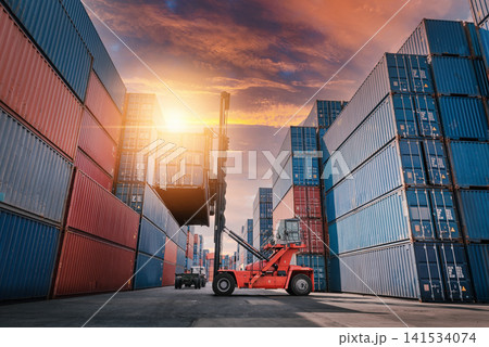 Shipping Containers and Reach Stacker in Cargo Yard at Sunset Shipping Containers and Reach Stacker in Cargo Yard at Sunset 141534074