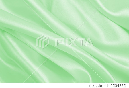 Smooth elegant green silk or satin luxury cloth texture as abstract background. Luxurious background design 141534825