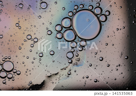 Oil bubbles and multicolored surface creating an abstract liquid texture Oil bubbles and multicolored surface creating an abstract liquid texture 141535063