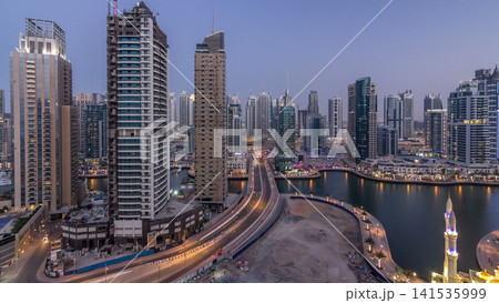 Beautiful aerial top view day to night transition timelapse of Dubai Marina canal 141535999