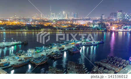 Dubai creek landscape day to night timelapse with boats and ship near waterfront Dubai creek landscape day to night timelapse with boats and ship near waterfront 141536012