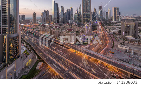 Skyline view of the buildings of Sheikh Zayed Road and DIFC day to night timelapse in Dubai, UAE. 141536033