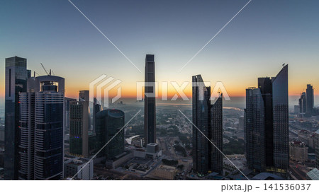 Dubai downtown skyline with tallest skyscrapers and traffic on highway night to day timelapse Dubai downtown skyline with tallest skyscrapers and traffic on highway night to day timelapse 141536037