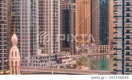 Dubai Marina skyscrapers and promenade aerial night to day timelapse, Dubai, United Arab Emirates Dubai Marina skyscrapers and promenade aerial night to day timelapse, Dubai, United Arab Emirates 141536048