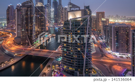Aerial view of Dubai Marina residential and office skyscrapers with waterfront day to night timelapse Aerial view of Dubai Marina residential and office skyscrapers with waterfront day to night timelapse 141536064