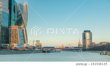 Moscow City skyscrapers and frozen river in winter at sunset timelapse. Moscow City skyscrapers and frozen river in winter at sunset timelapse. 141536135