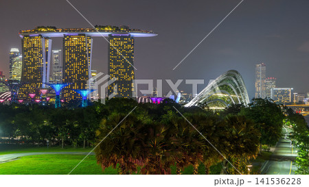 Marina Bay Sands, Gardens by the bay with cloud forest, flower dome and supertrees day to night timelapse after sunset Marina Bay Sands, Gardens by the bay with cloud forest, flower dome and supertrees day to night timelapse after sunset 141536228