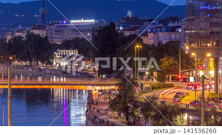 Aerial view along the Danube Canal in Vienna day to night timelapse after sunset Aerial view along the Danube Canal in Vienna day to night timelapse after sunset 141536260