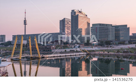 Donaustadt Danube City night to day timelapse is a modern quarter with skyscrapers and business centres in Vienna, Austria. Donaustadt Danube City night to day timelapse is a modern quarter with skyscrapers and business centres in Vienna, Austria. 141536270