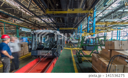 Conveyor assembly stage the body of tractor at big industrial factory timelapse Conveyor assembly stage the body of tractor at big industrial factory timelapse 141536275