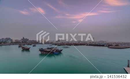 Sunset at Doha Bay timelapse with Traditional Wooden Dhow Fishing Boats. Sunset at Doha Bay timelapse with Traditional Wooden Dhow Fishing Boats. 141536432