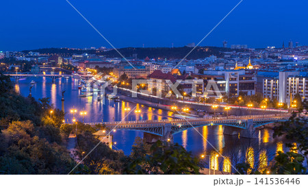 Aerial evening view of the Vltava River and illuminated bridges day to night timelapse, Prague Aerial evening view of the Vltava River and illuminated bridges day to night timelapse, Prague 141536446