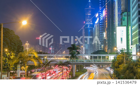 Hong Kong street with busy traffic and skyscraper office at dusk day to night timelapse. 141536479