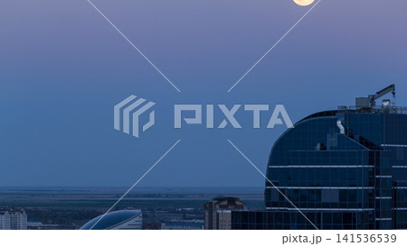 Nazarbayev Center and blue tower, after Sunset with full moon rising. Astana, Kazakhstan 141536539