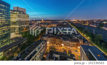 Aerial day to night timelapse of Brussels urban landscape blending office skyscrapers with residential areas. Aerial day to night timelapse of Brussels urban landscape blending office skyscrapers with residential areas. 141536563