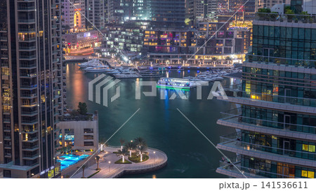 Aerial view of Dubai Marina residential and office skyscrapers with waterfront day to night timelapse Aerial view of Dubai Marina residential and office skyscrapers with waterfront day to night timelapse 141536611