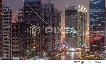 Residential and office buildings in Jumeirah lake towers district day to night timelapse in Dubai Residential and office buildings in Jumeirah lake towers district day to night timelapse in Dubai 141536628