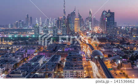 Dubai skyline after sunset with beautiful city center lights and Sheikh Zayed road traffic timelapse, Dubai, United Arab Emirates Dubai skyline after sunset with beautiful city center lights and Sheikh Zayed road traffic timelapse, Dubai, United Arab Emirates 141536662