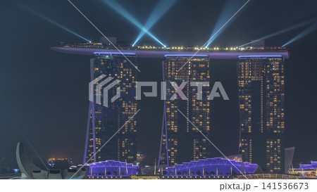 Fifty-five storeys high Marina Bay Sands Hotel dominates the skyline at Marina Bay in Singapore aerial night timelapse. Fifty-five storeys high Marina Bay Sands Hotel dominates the skyline at Marina Bay in Singapore aerial night timelapse. 141536673