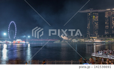 Fireworks display over the Marina Bay waterfront in celebration of the Lunar New Year timelapse 141536691