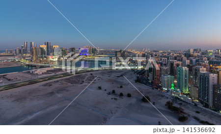 Aerial skyline of Abu Dhabi city centre from above day to night timelapse Aerial skyline of Abu Dhabi city centre from above day to night timelapse 141536692