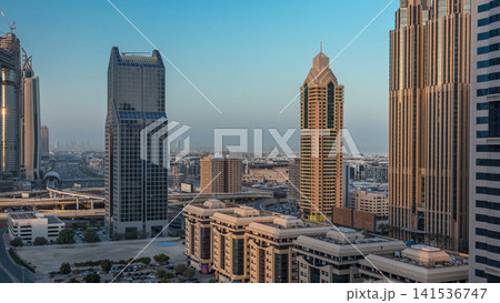 Dubai downtown skyline night to day timelapse and Sheikh Zayed road traffic, UAE 141536747