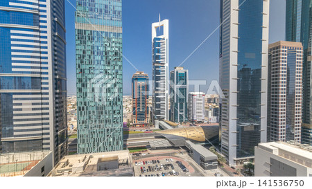 Skyline view of the buildings of Sheikh Zayed Road and DIFC all day timelapse in Dubai, UAE. Skyline view of the buildings of Sheikh Zayed Road and DIFC all day timelapse in Dubai, UAE. 141536750