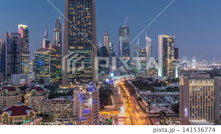 Skyline view of the buildings of Sheikh Zayed Road and DIFC day to night timelapse in Dubai, UAE. Skyline view of the buildings of Sheikh Zayed Road and DIFC day to night timelapse in Dubai, UAE. 141536774