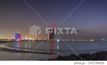 Dubai skyline with Burj Al Arab hotel day to night timelapse. Dubai skyline with Burj Al Arab hotel day to night timelapse. 141536820