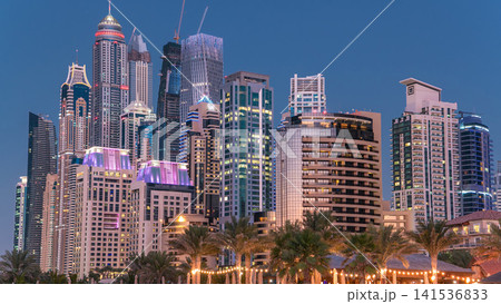 Modern skyscrapers day to night timelapse in jumeirah beach residence in Dubai, JBR Modern skyscrapers day to night timelapse in jumeirah beach residence in Dubai, JBR 141536833