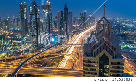 Modern skyscrapers and busy evening highways day to night timelapse in luxury Dubai city, Dubai, United Arab Emirates Modern skyscrapers and busy evening highways day to night timelapse in luxury Dubai city, Dubai, United Arab Emirates 141536835