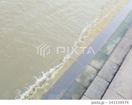 Water splashing against stone steps in Yokohama port, Japan Water splashing against stone steps in Yokohama port, Japan 141539574
