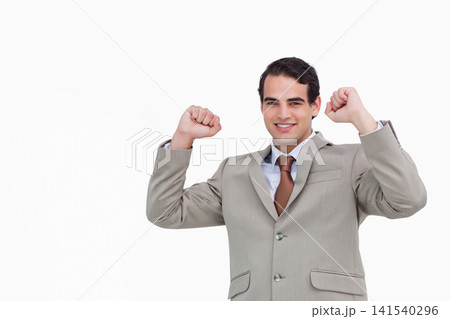 Man wearing suit jacket shirt brown necktie showing buttons pocket flaps raising fists studio Man wearing suit jacket shirt brown necktie showing buttons pocket flaps raising fists studio 141540296