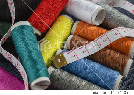 Colorful Sewing Threads and Measuring Tape. Colorful Sewing Threads and Measuring Tape. 141544059