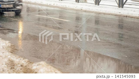 Rainy city street with wet pavement and reflections Rainy city street with wet pavement and reflections 141545093