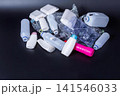 Collection of empty plastic bottles and containers on black surface 141546033