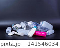 Collection of used insulin pens and cartridges on dark background 141546034