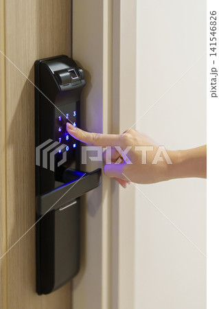 Hand press PIN number for smart digital door lock while open or close the door at home or apartment. NFC Technology, Fingerprint scan, keycard, smartphone and contactless lifestyle concepts Hand press PIN number for smart digital door lock while open or close the door at home or apartment. NFC Technology, Fingerprint scan, keycard, smartphone and contactless lifestyle concepts 141546826